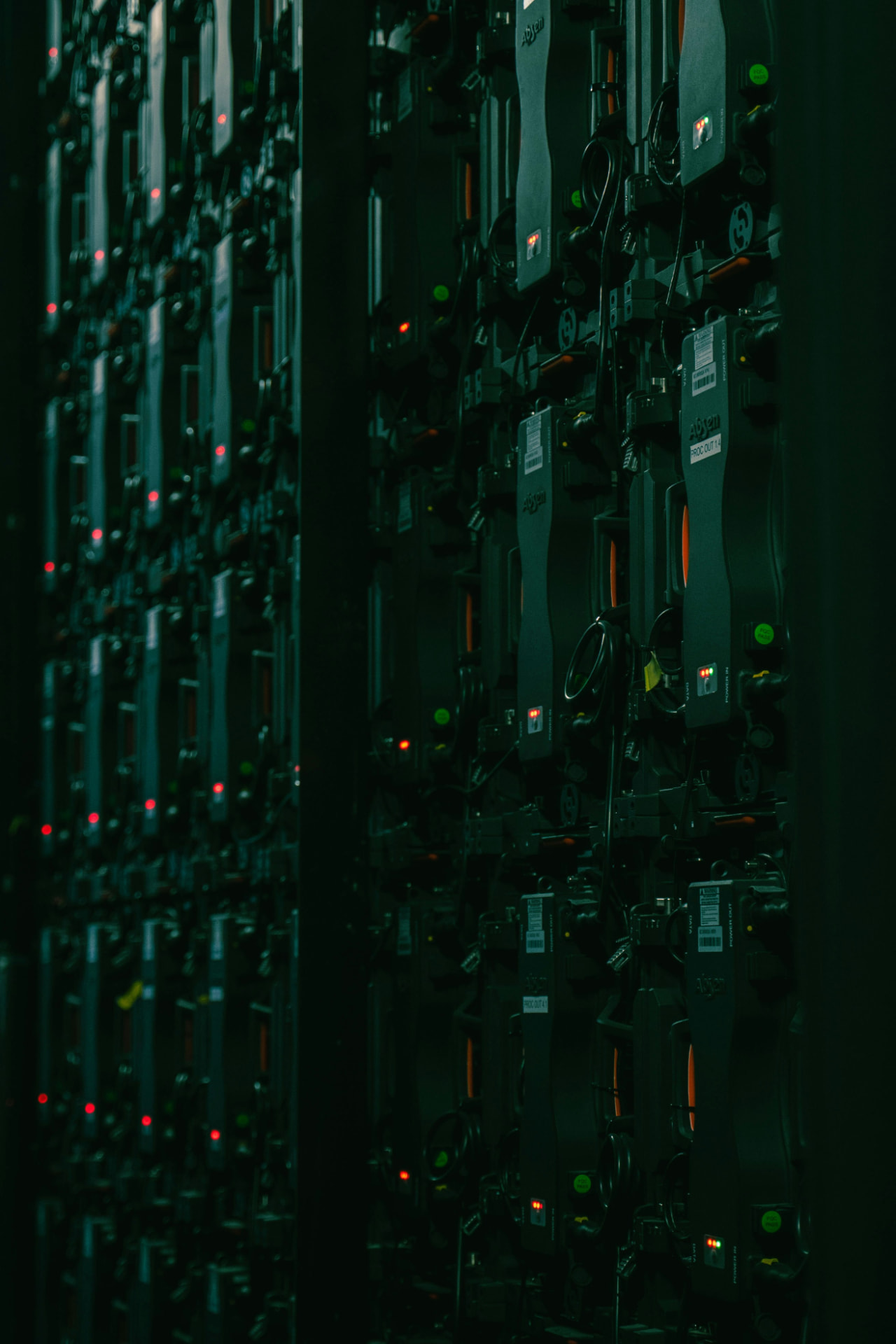 Racked equipment with status indicator lights in a dim server room